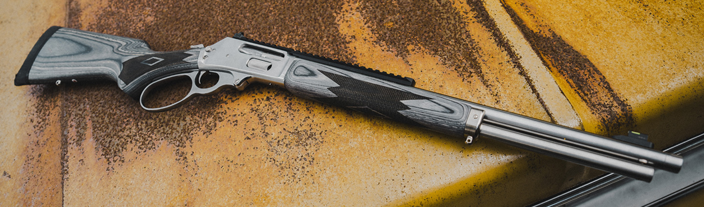 Lever action firearm on the hood of a truck